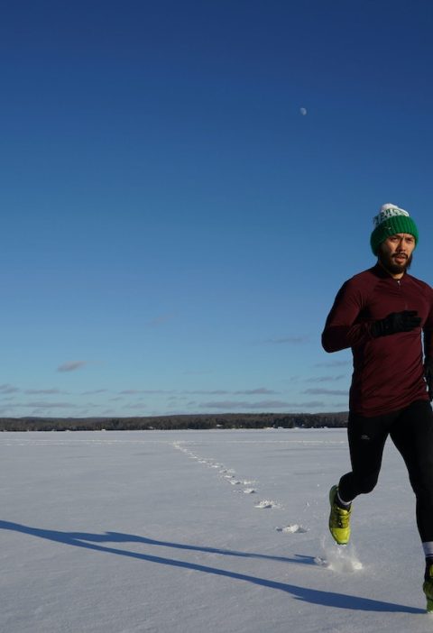 biegacz rozgrzewający się pod czas zimowej słonecznej pogody